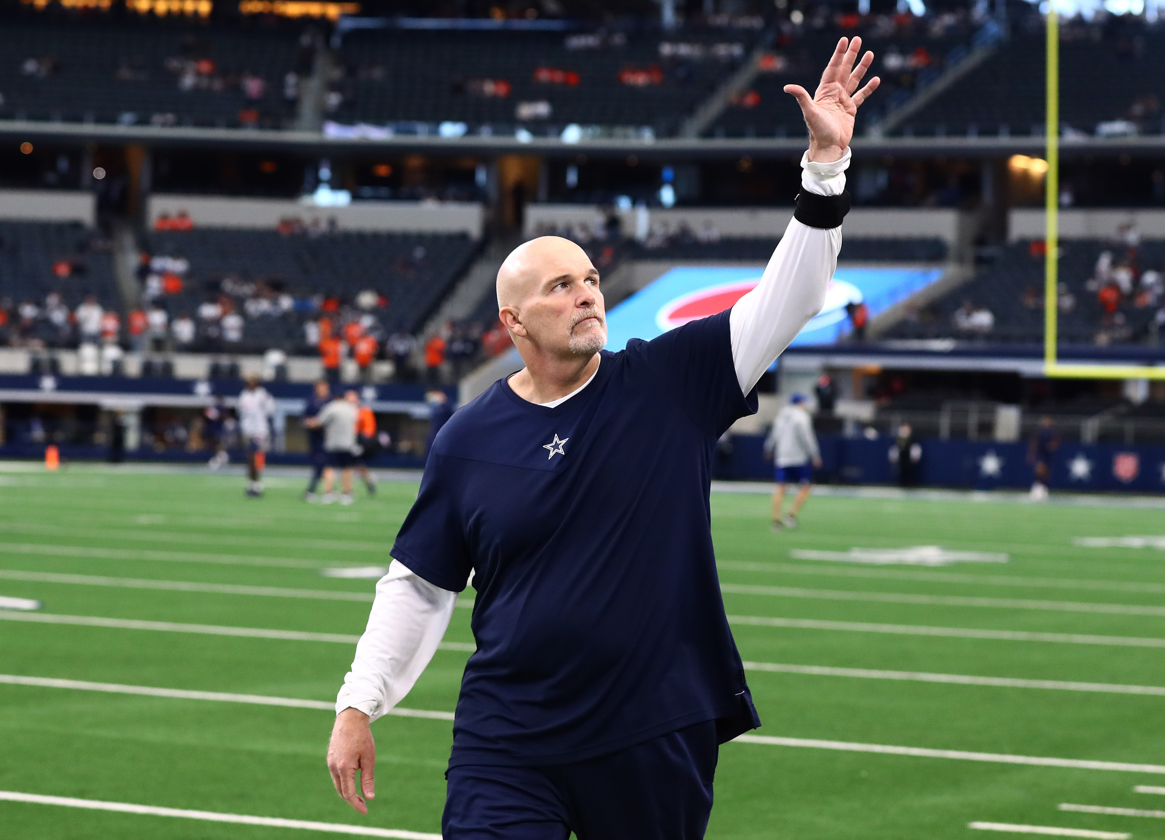 Dan QUinn walks off the field waving